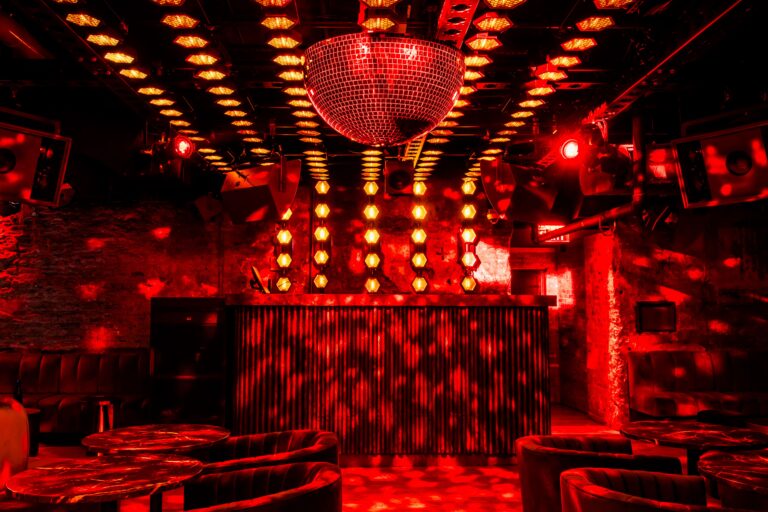 Astonishing disco ball with red light suspended from the ceiling's central position.