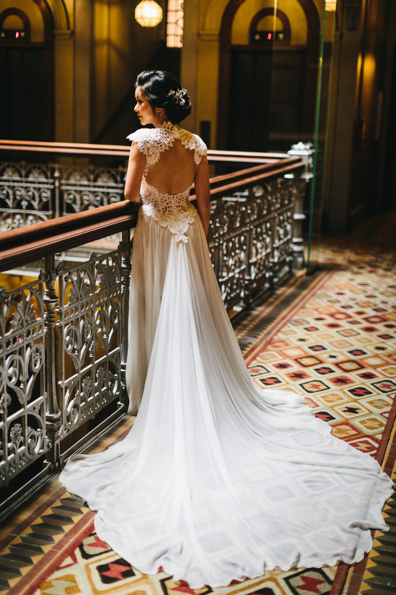 A beautiful girl in a wedding dress is standing in the corridor