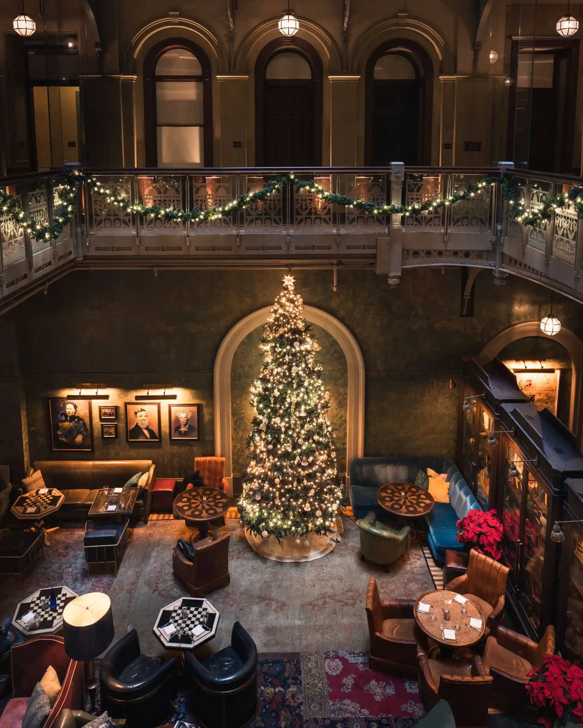 Aerial photo captures the lobby with assorted cozy chairs near a festive Christmas tree.